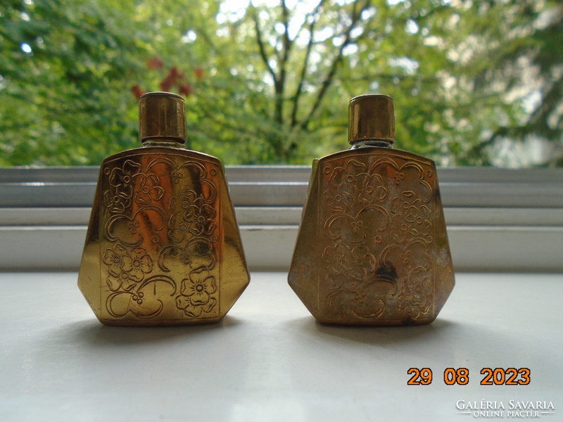 2 perfume bottles in an oriental gilded chiseled flower pattern case, one of which contains 3/4 perfume