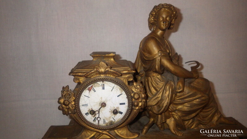 Antique fireplace clock with woman statue