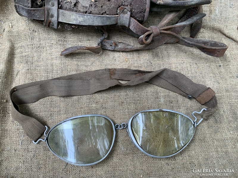 Old motorcycle pilot glasses may be warlike, showing military markings on a helmet
