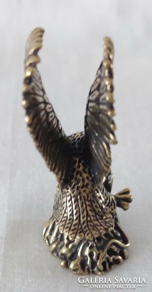 Miniature brass figure of a flying eagle catching a snake