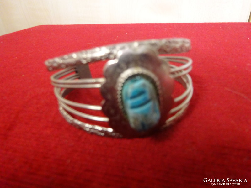 Silver-plated bisque bracelet, expands, with blue stones. Jokai.
