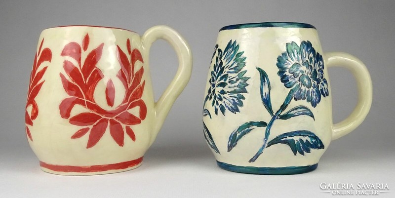 A pair of ceramic mugs with handles marked 1O061 weaver kati