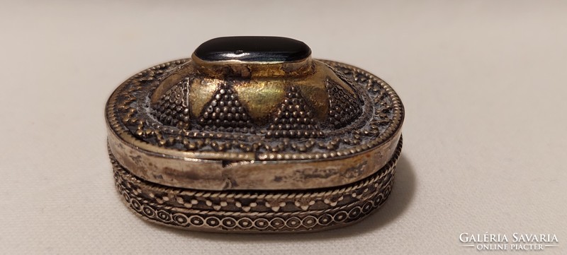 Decorative silver box with stone on top