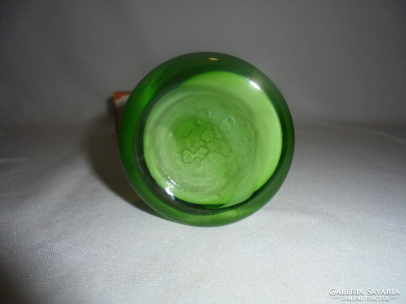Old green glass vase with twisted decoration in a circle
