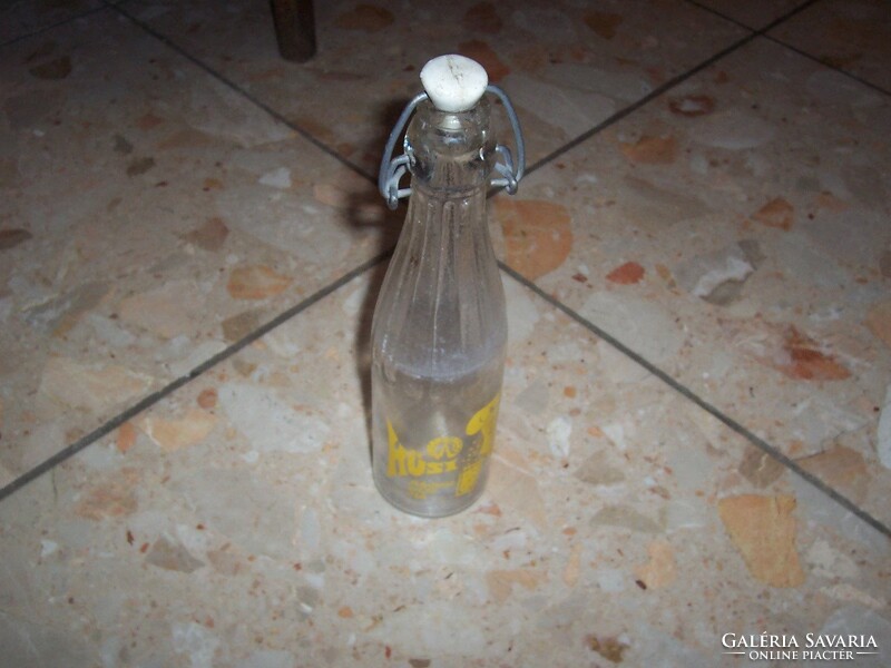 An old Hüsi soft drink bottle is a rarer yellow color