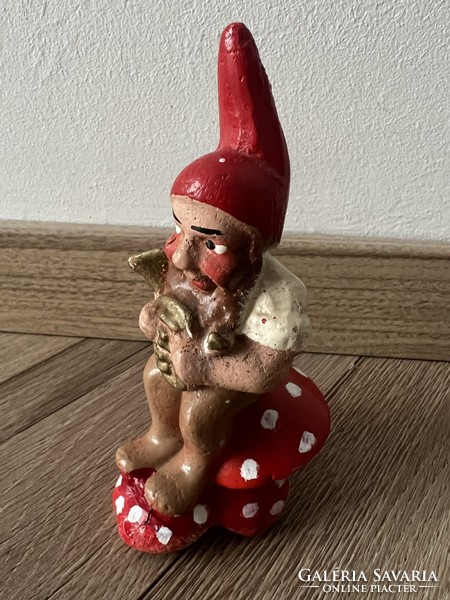 Antique gypsum Christmas decoration with a dwarf sitting on a mushroom and a horn
