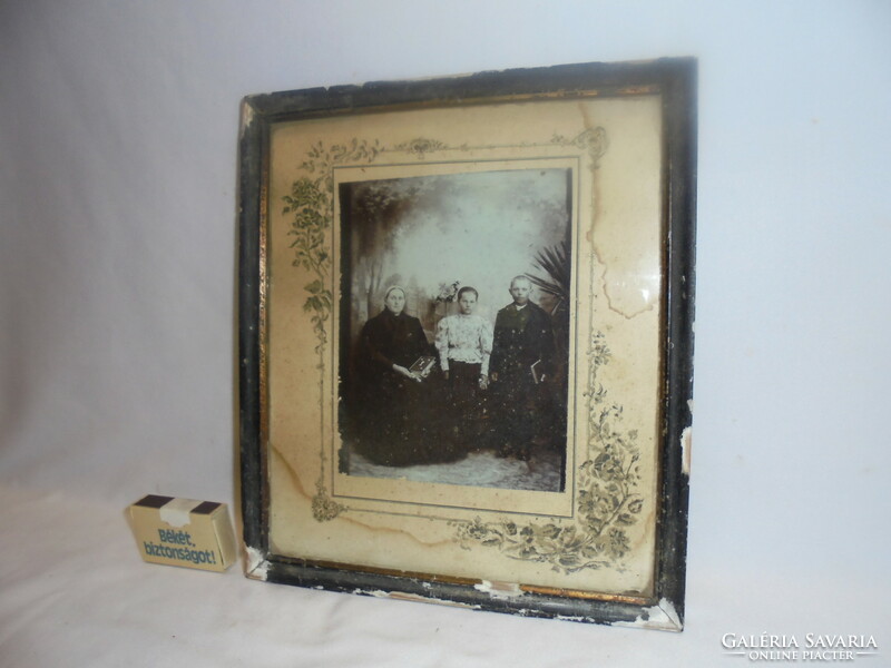 Antique family photo in a frame, under glass