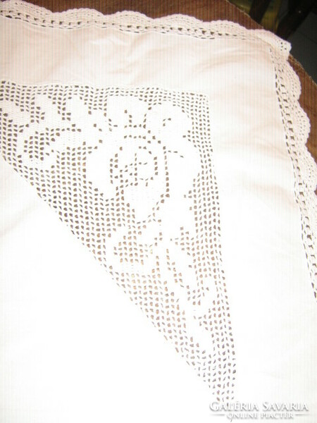 Fabulous handmade crochet rose with lace insert on crocheted edge of snow-white antique tablecloth
