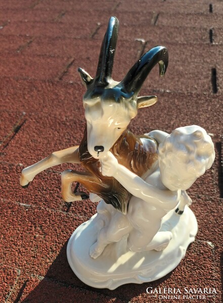 Puttó with a goat - German crown stamped porcelain sculpture figure