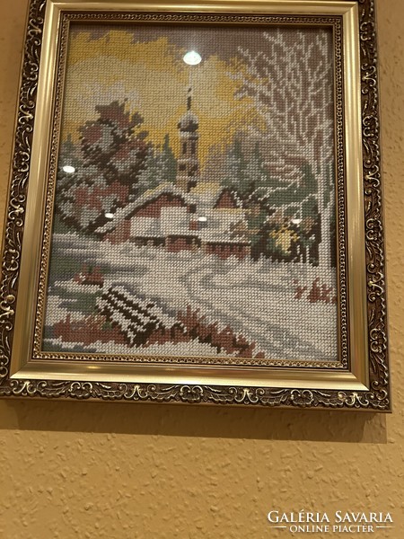 Framed, glazed needle tapestry of a winter landscape with a church, in a beautiful gold frame