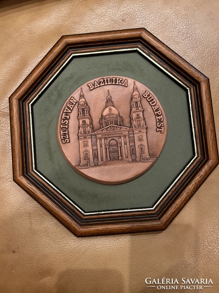 Saint Stephen's Basilica wall decoration, stone carving in a brown wooden frame.