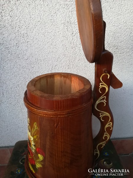 A wooden cup decorated with a folk motif, 35 cm high including the handle, 20 cm in diameter at the bottom.