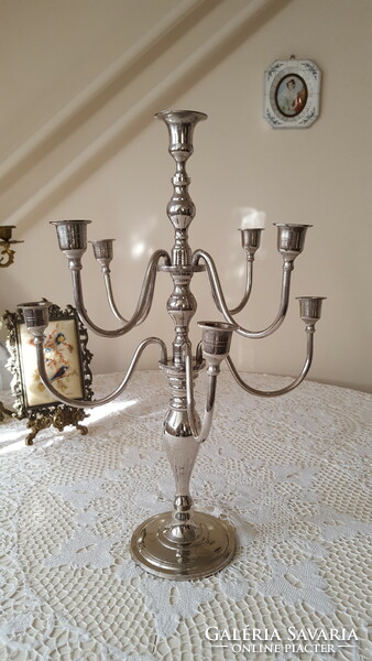 Silver-colored, nine- or five-branched candlestick