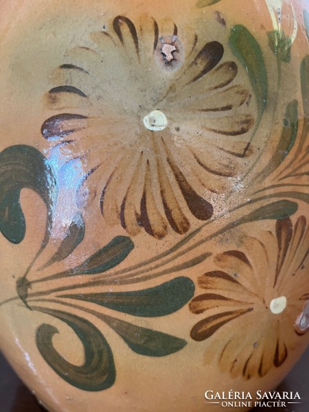 Large antique brown glazed earthenware pot with ceramic flower motif