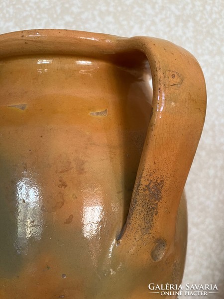 Large antique brown glazed earthenware pot with ceramic flower motif