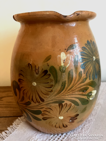 Large antique brown glazed earthenware pot with ceramic flower motif