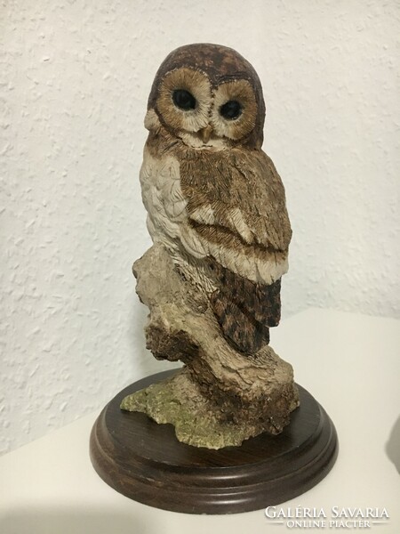Vintage owl statue on wooden base