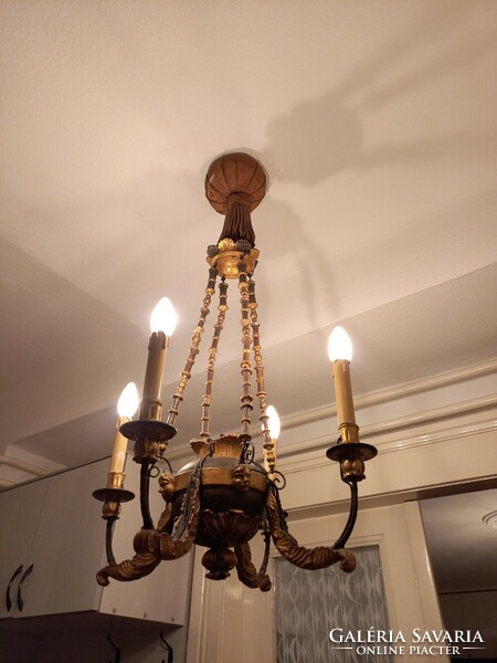 Very old chandelier with painted and gilded figural decoration