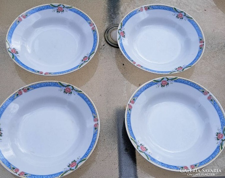 4 deep soup plates with a flower pattern.