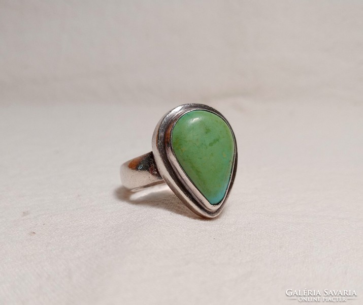Old silver ring with a large greenish turquoise