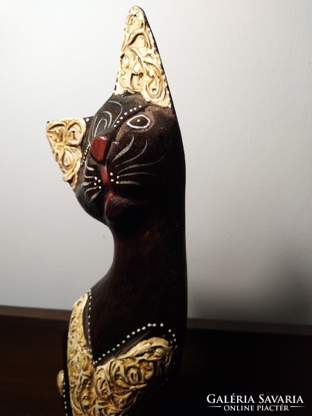 A carved wooden cat statue