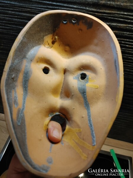 A pair of ceramic theater masks with a laughing-amazing face
