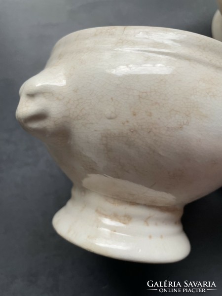 A mature earthenware soup cup with a lion's head