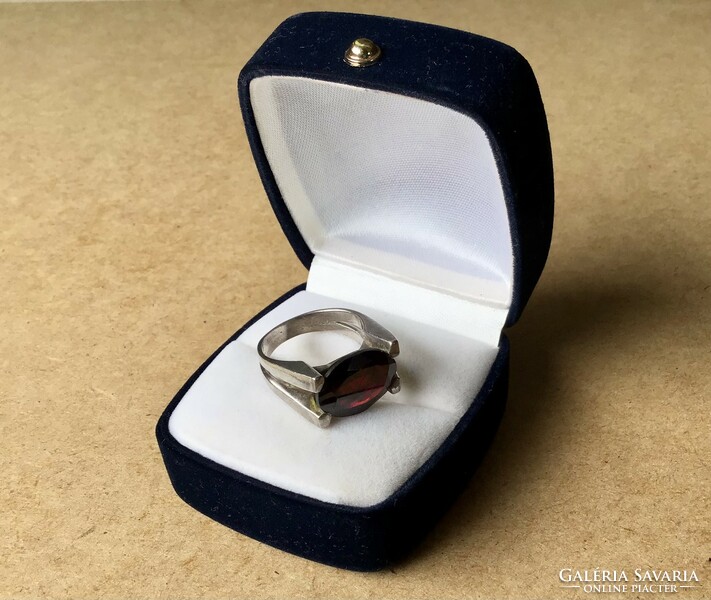 Old silver ring with a large garnet stone