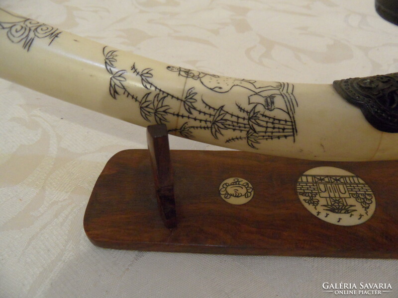 Far Eastern hand-painted, bone opium pipe on a wooden stand