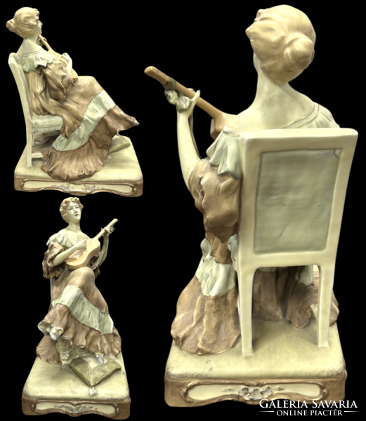 A very rare 100-year-old royal dux figure of a woman playing guitar