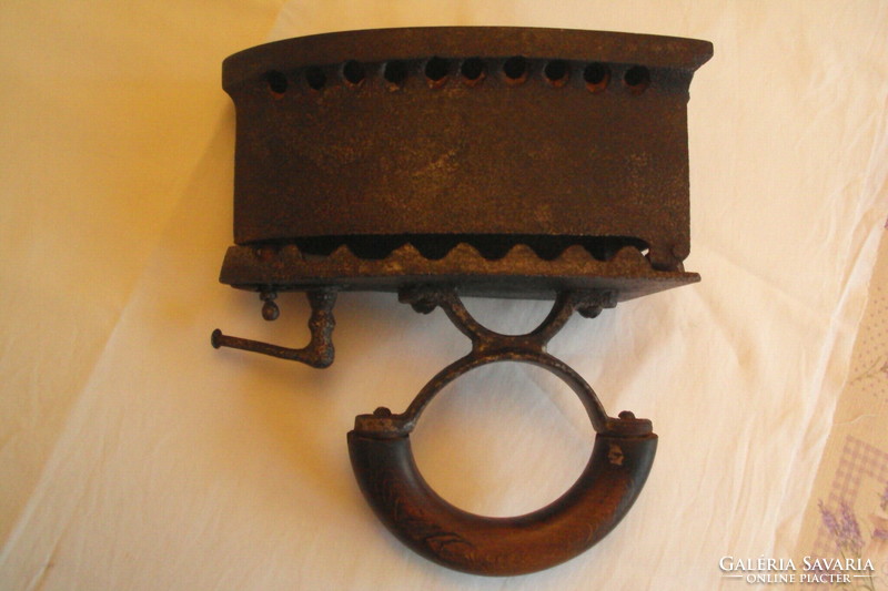 Antique fiery iron --- a kitchen tool made of cast iron heated with embers, used for ironing.