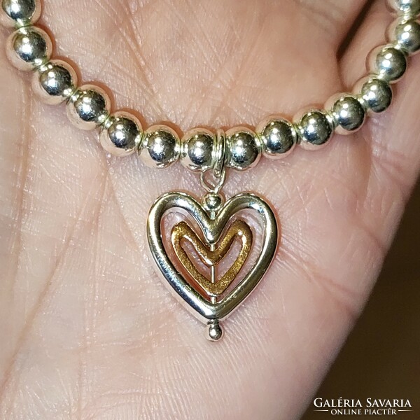 New silver-colored rubber bracelet with a gold-plated heart