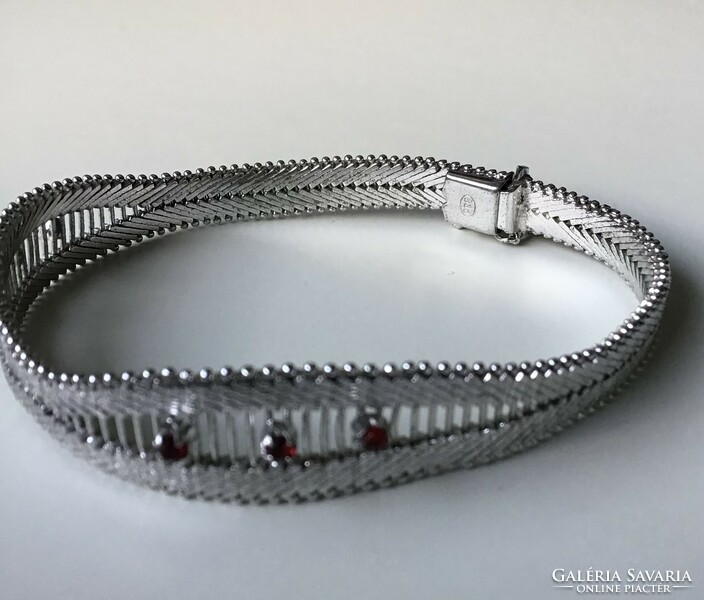 Brand new silver bracelet decorated with red stones