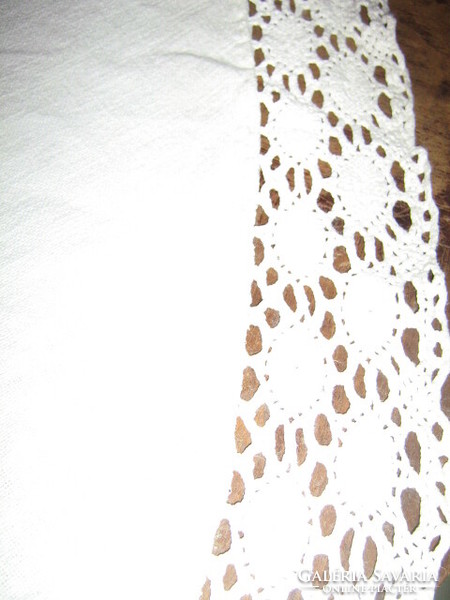 Wonderful white crocheted oval woven tablecloth with lacy edges