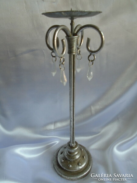 Wrought iron candle holder. Its height is 38.5 cm.