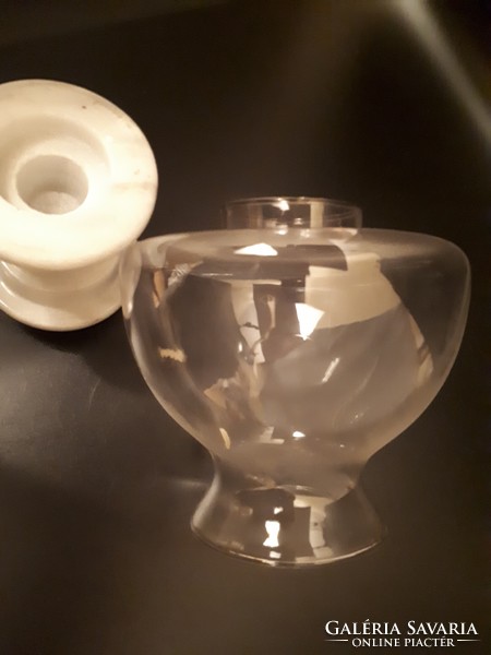 A kerosene lamp holder with a candle on a marble base