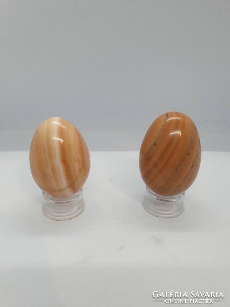 Onyx marble mineral eggs on a plastic holder