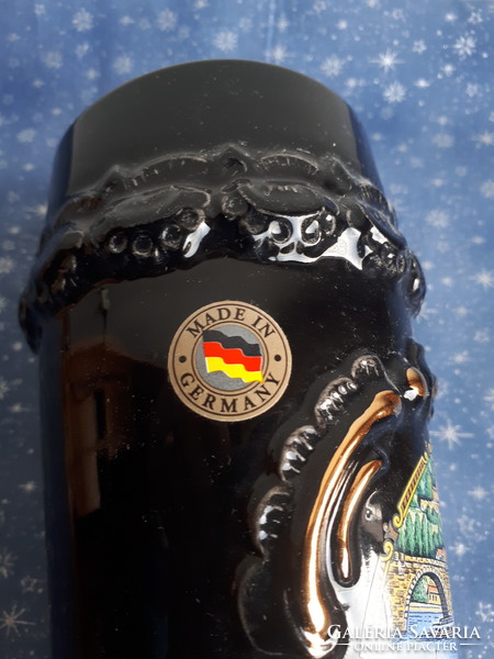 German brown glazed ceramic beer mug with plastic surface