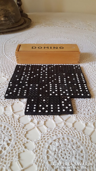 28 dominoes in an old wooden box.
