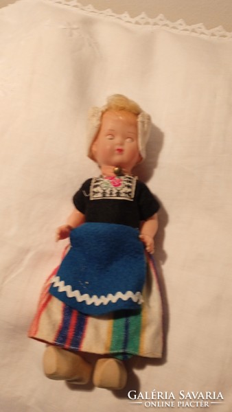 Old rubber sleeping doll in folk costume