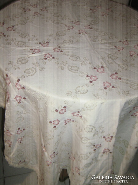 Beautiful elegant damask tablecloth with cross-stitch embroidery with a flower pattern