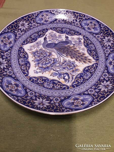 A large plate with a beautiful peacock