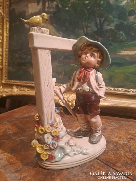 The little boy scout with a bird: German porcelain figure