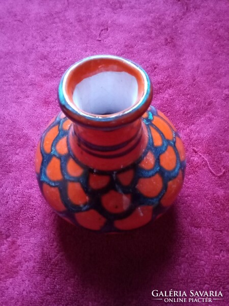Red ceramic vase with blue pattern
