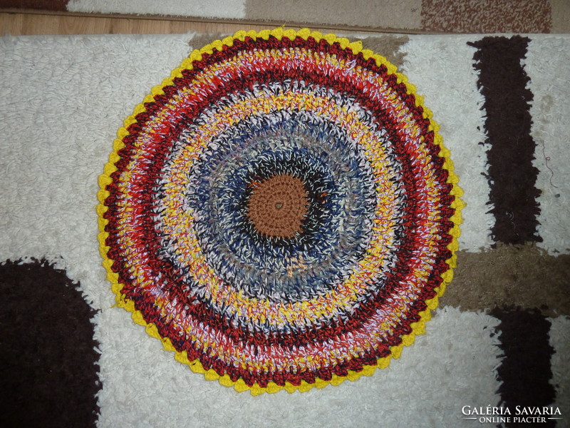 Colored crocheted round rug with a diameter of 60 cm