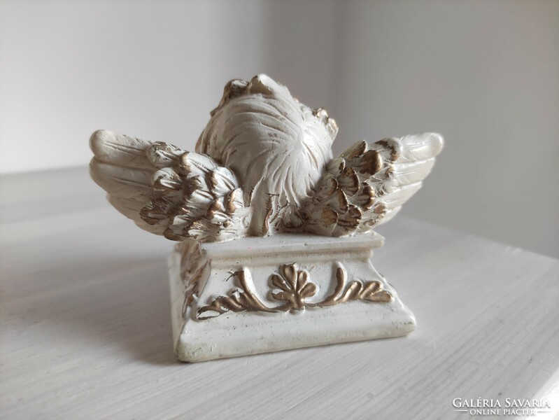 The singing ceramic candle holder and the plastic angel face disguised as devout marble are a pair