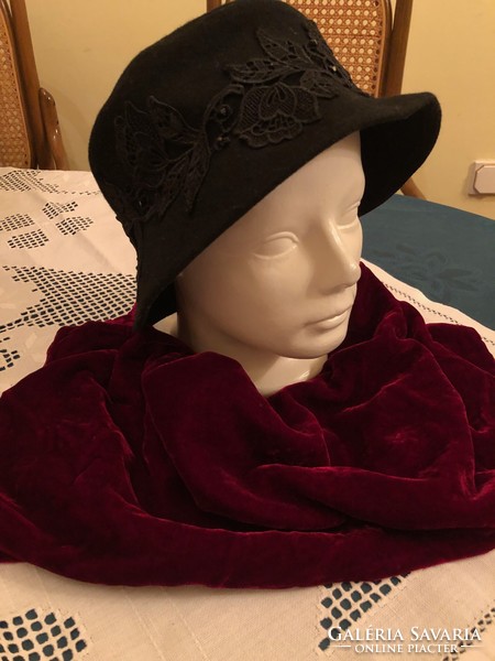 Elegant black women's hat and red velvet scarf