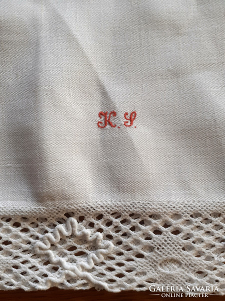 2 antique monogrammed cushion covers with lace edges.