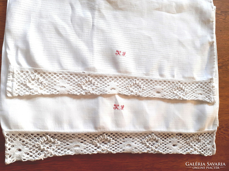 2 antique monogrammed cushion covers with lace edges.