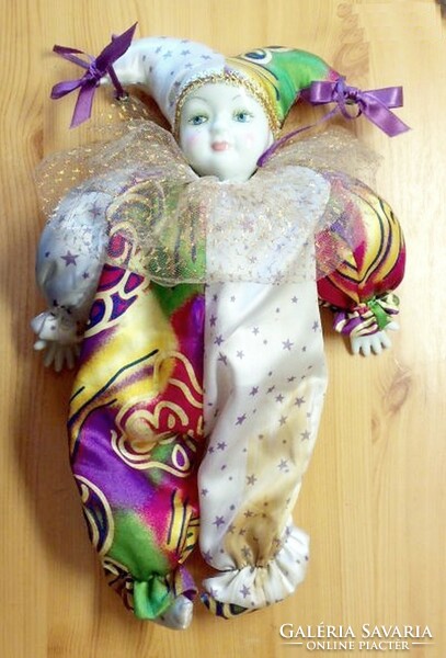 A clown doll with a porcelain head, a carnival souvenir from Italy.